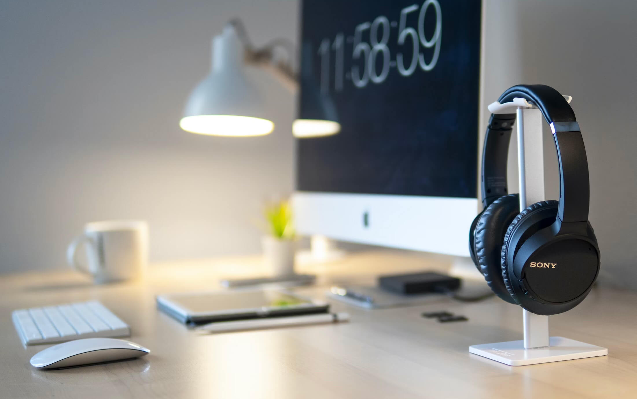 A tidy minimalist desk with a laptop and a notebook